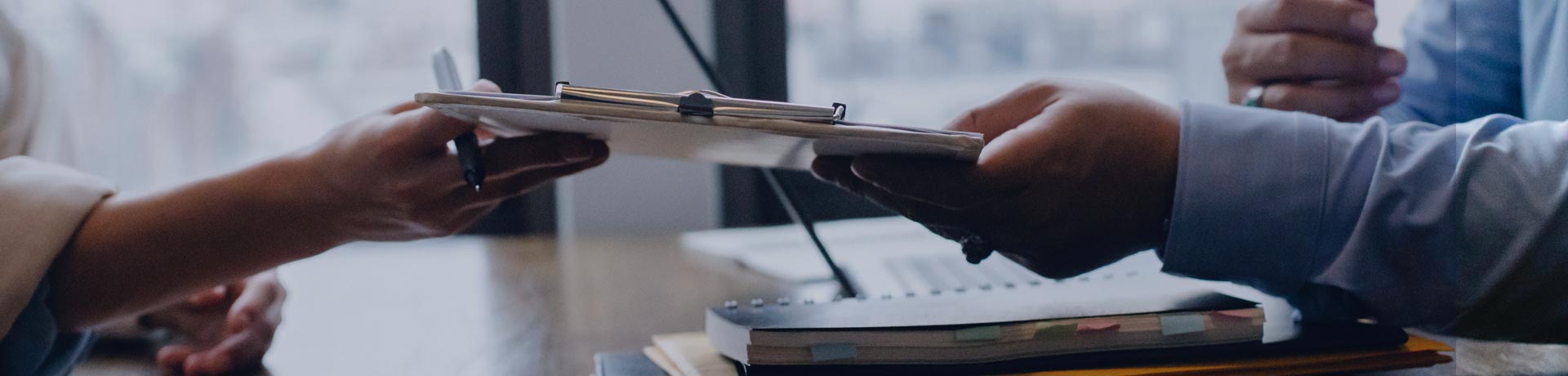 Two persons exchanging a document