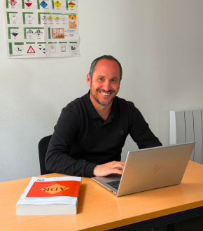 Man working on a computer with ADR book
