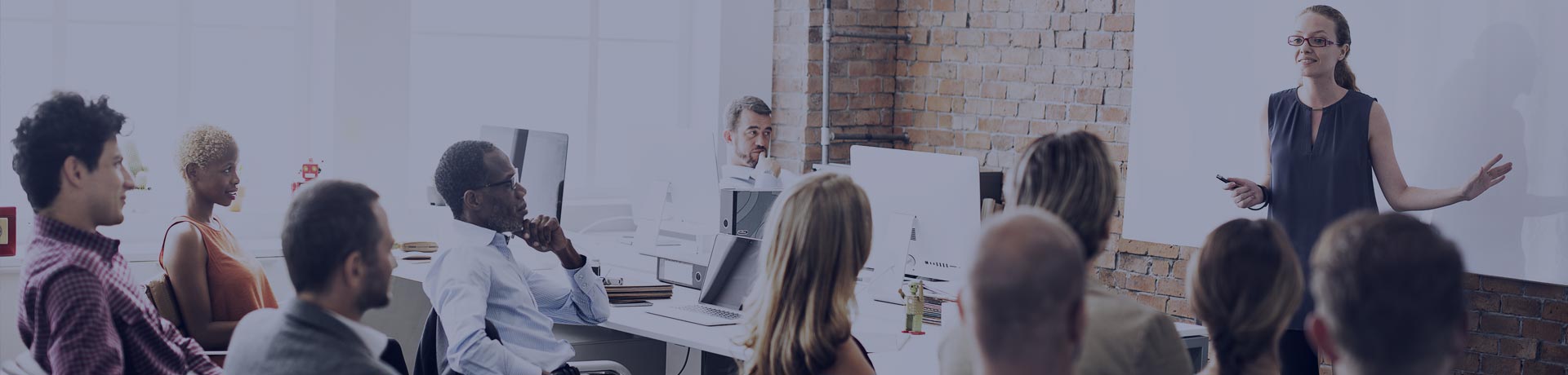 Training room with a trainer in front of her colleagues