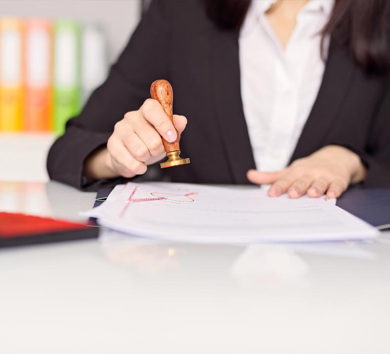 woman putting a stamp on a report