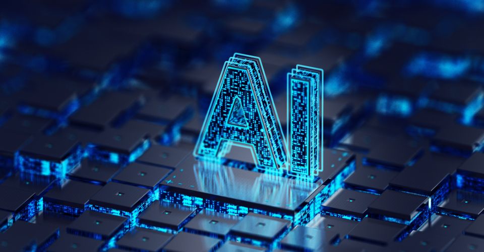 Le sigle "IA" est représenté en 3D, lumineux, sur un circuit imprimé aux reflets bleus, pour illustrer l'intelligence artificielle.