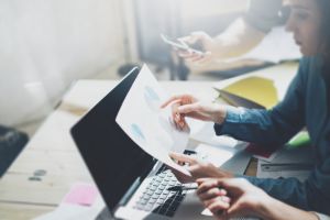 Une femme responsable d'entreprise tient des papiers avec des graphiques