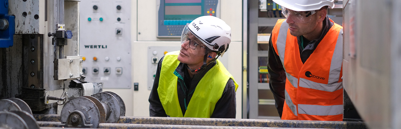 Deux collaborateurs Apave en train de réaliser le contrôle visuel d'une machine industrielle