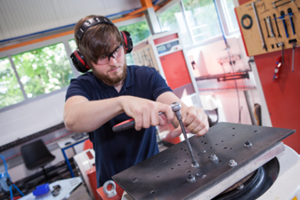 A technician working on a vibration generator