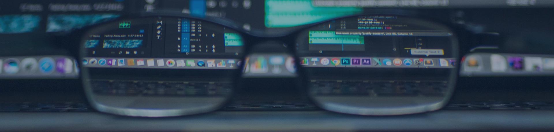 glasses in front of an encrypted computer screen