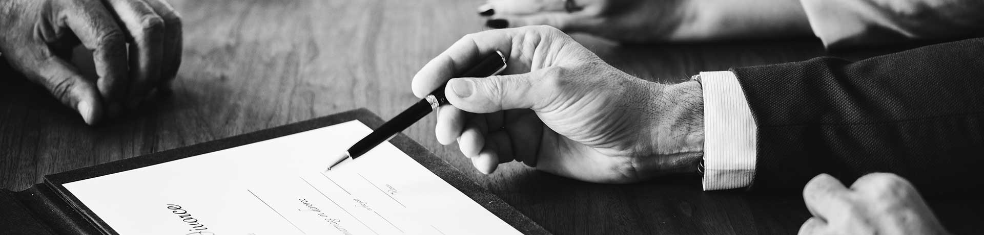 3 people signing a contract