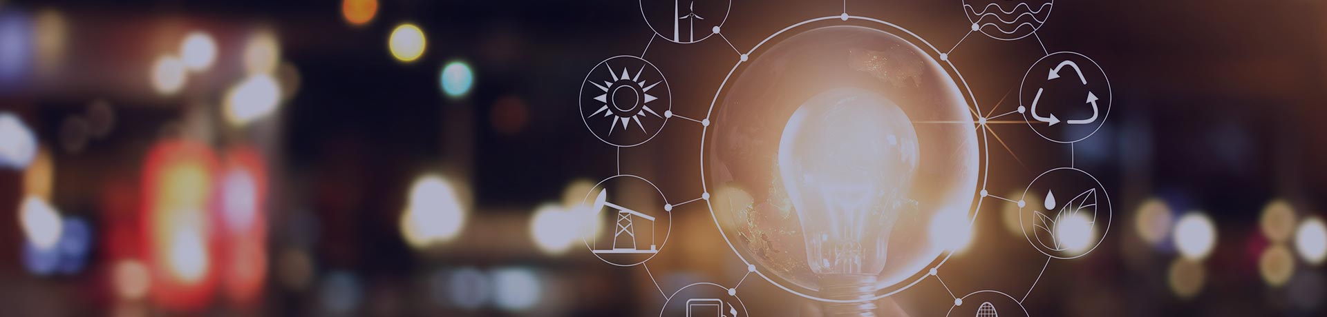 Une main qui tient une ampoule allumée autour de laquelle figure divers pictogrammes énergies