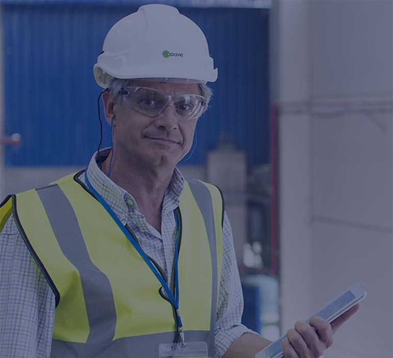 A man in a yellow waistcoat and a white safety helmet