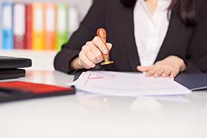 A woman stamping a document